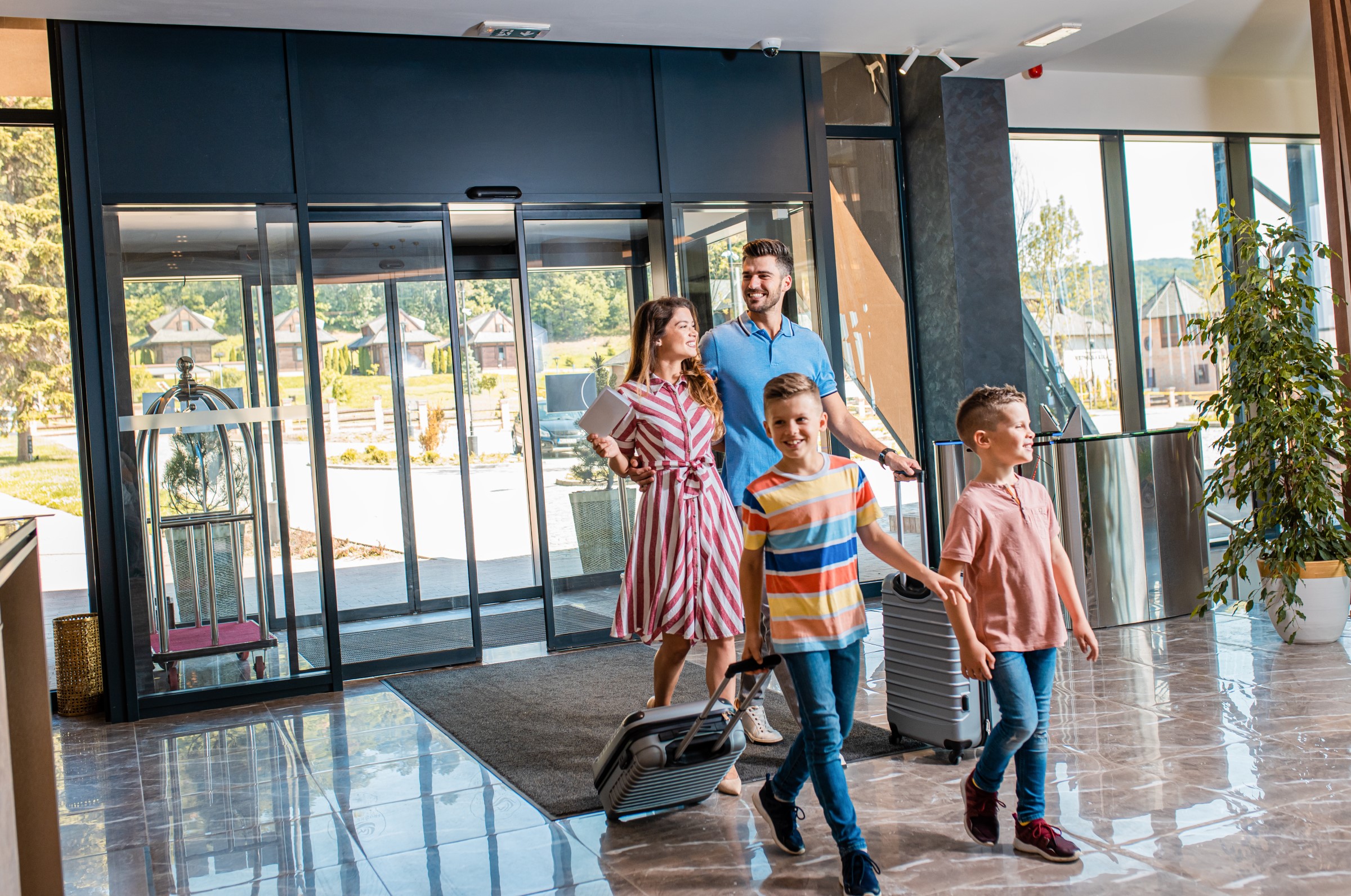 Family checking in at a hotel front desk