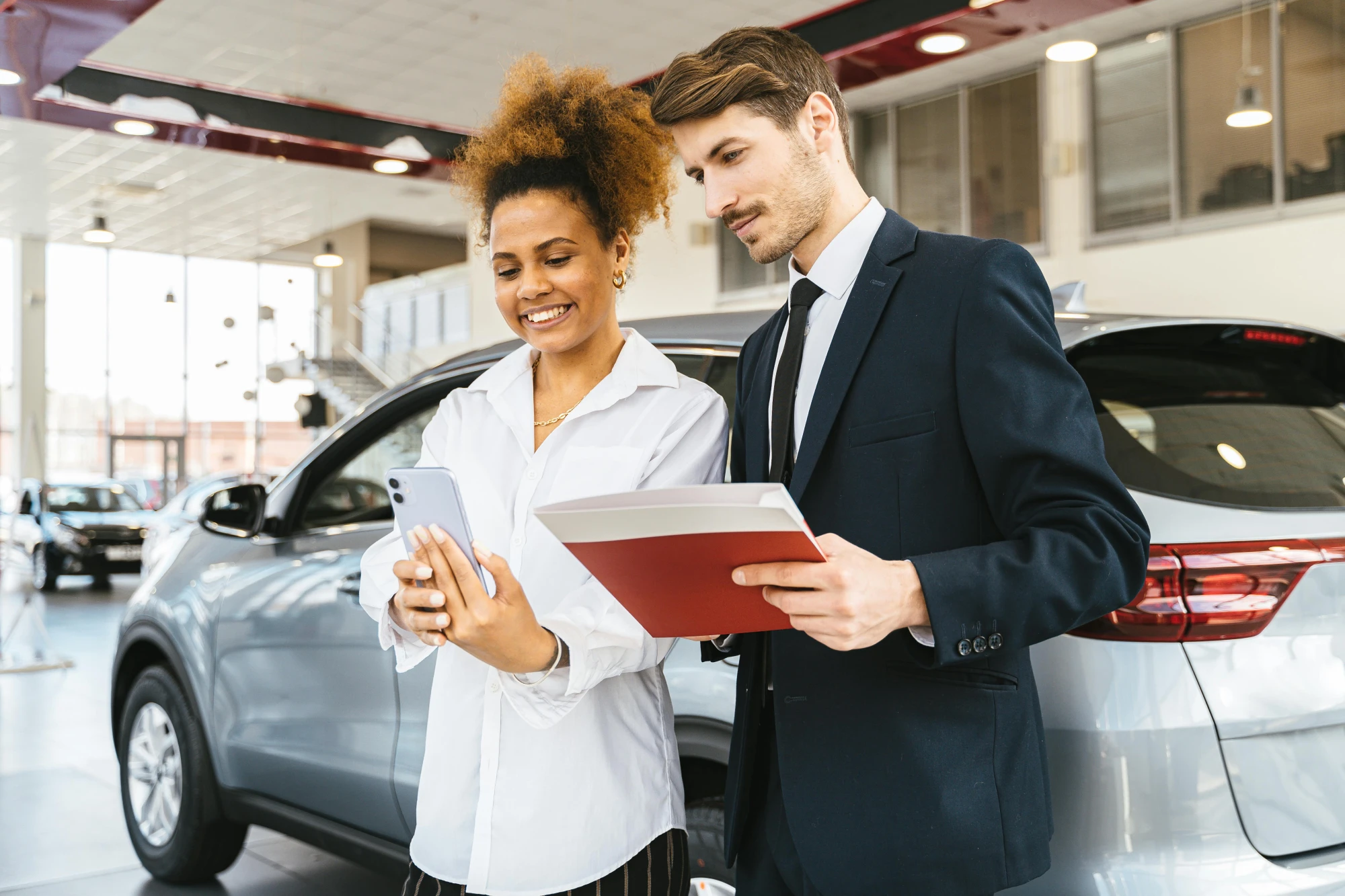 Customers speaking with a dealership associate in a showroom