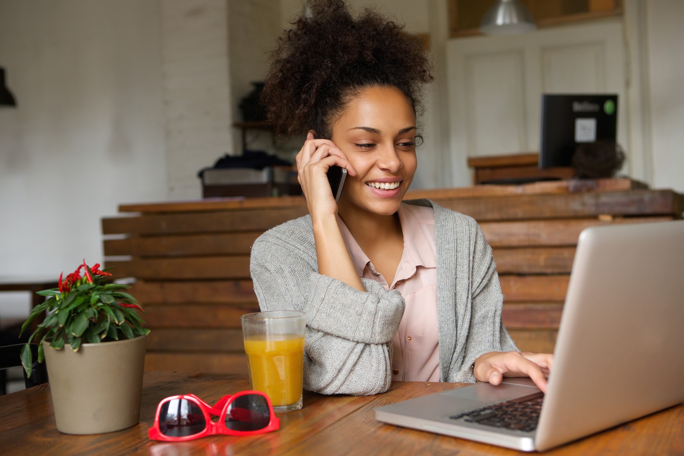 Shopper using a phone and laptop to manage assignments